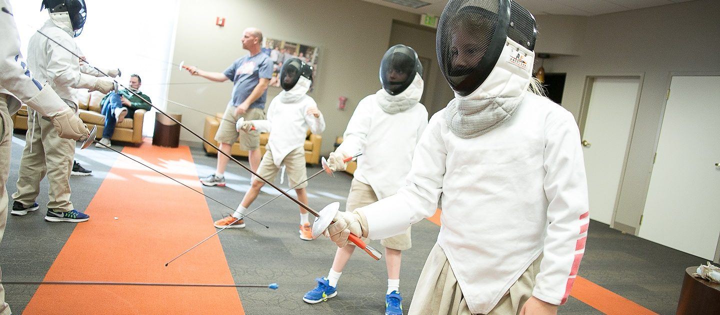 Children in an after-school fencing class