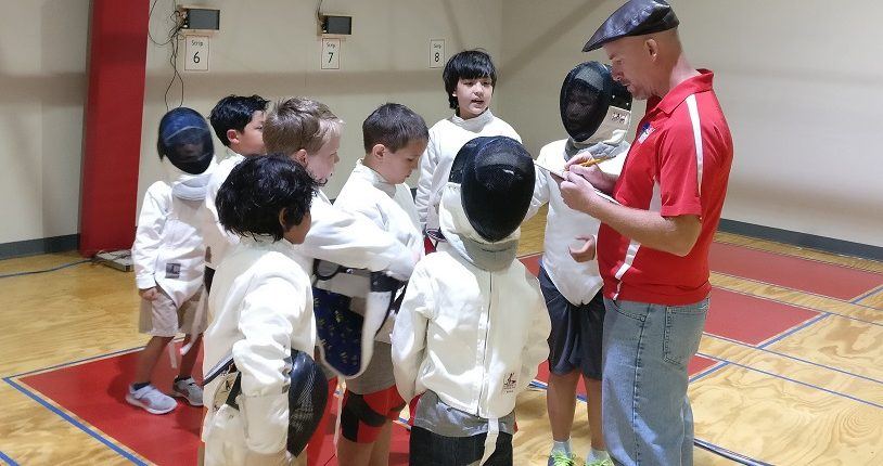 Coach Dan and a group of fencers at the school championship