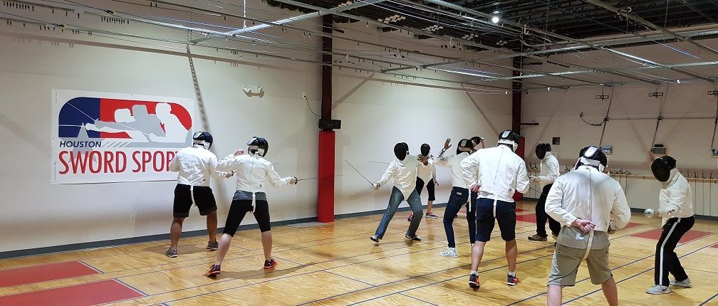 New fencers try out fencing for the first time at our grand opening.